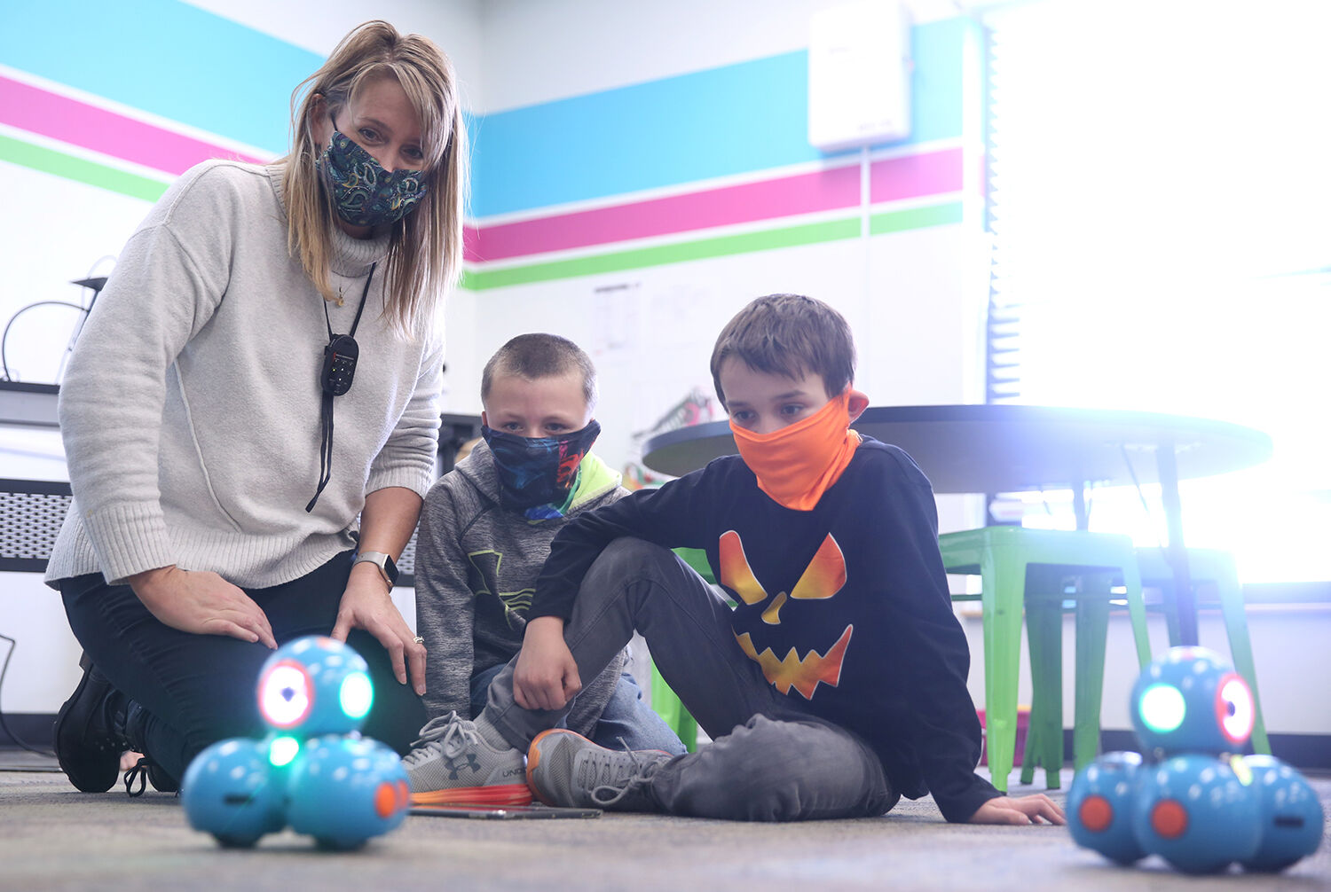Krista Sweckard works with Griffin Ruby, center, and Sawyer Kolb on their robot pattern